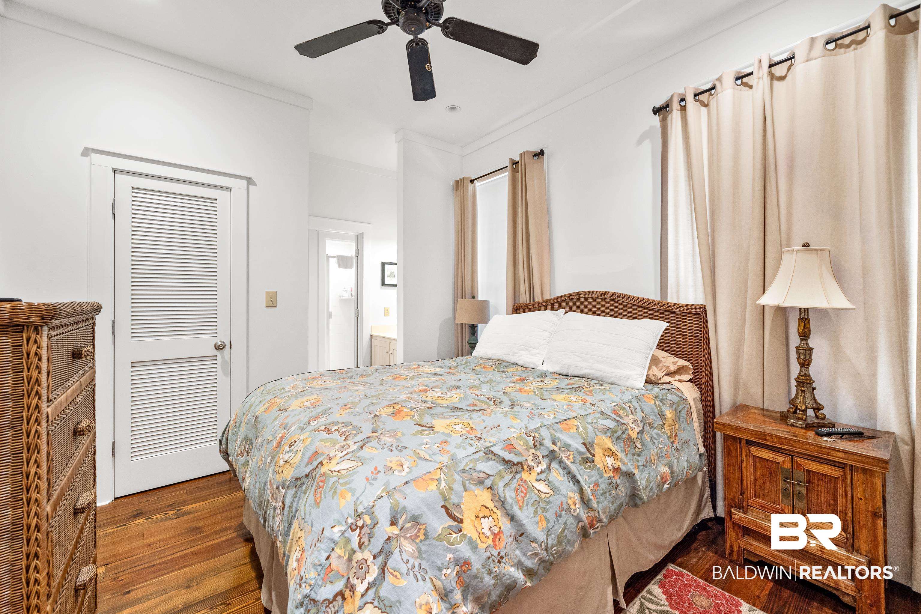 25773 Canal Road, Unit 10 Orange Beach, AL 36561 - Photo 14 of 40 Bedroom with a closet, ceiling fan, and beautiful hardwood floors