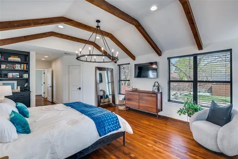 a bedroom with furniture and a large window