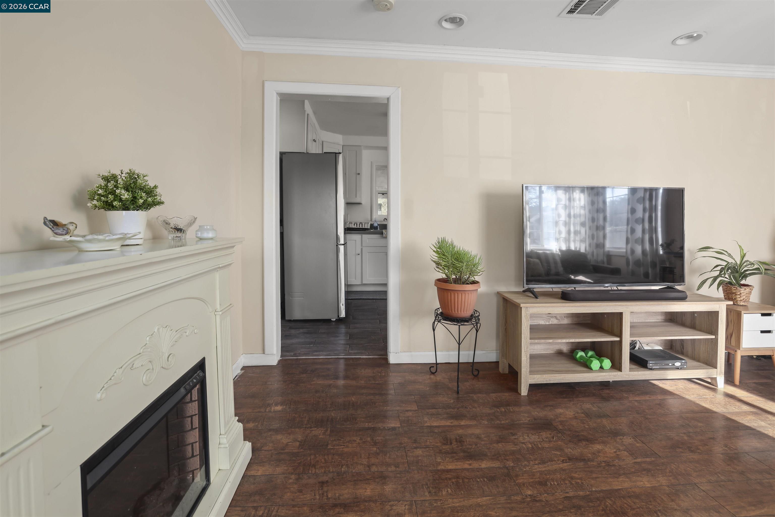 35 Jefferson Street Bay Point, CA 94565 - Photo 3 of 13 a living room with furniture a flat screen tv and a fireplace