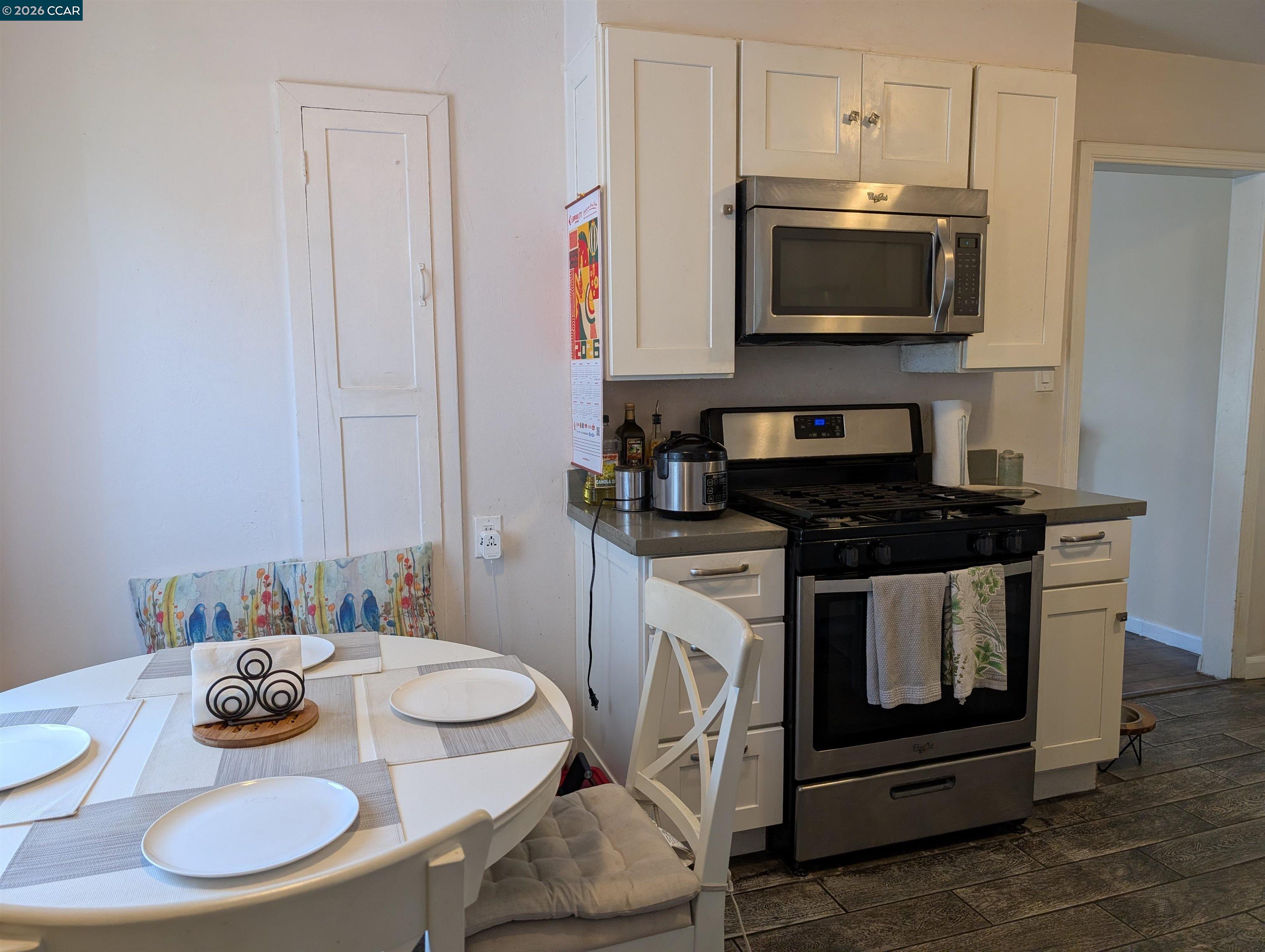 35 Jefferson Street Bay Point, CA 94565 - Photo 6 of 13 a kitchen with stainless steel appliances a stove a microwave and dining table