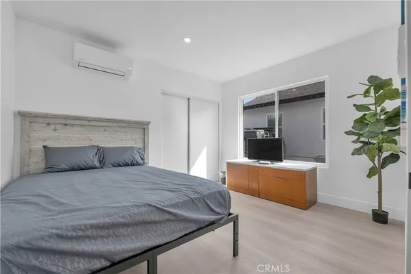 a bedroom with a bed and a potted plant
