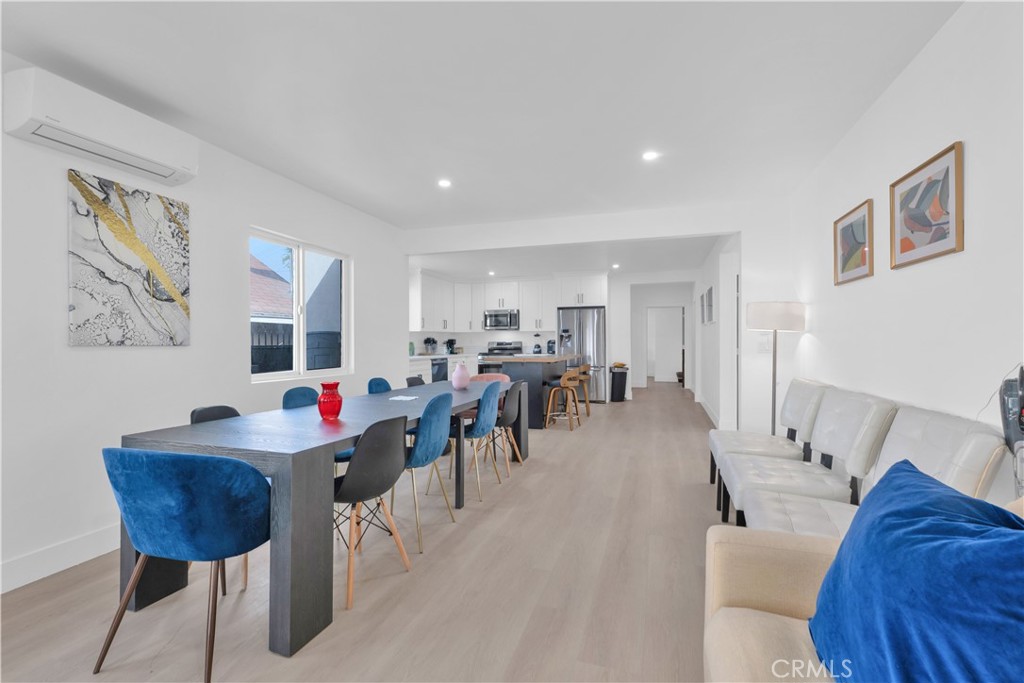 3115 Arvia Street, Unit 1A Los Angeles, CA 90065 - Photo 15 of 45 a living room with furniture and a dining table with wooden floor