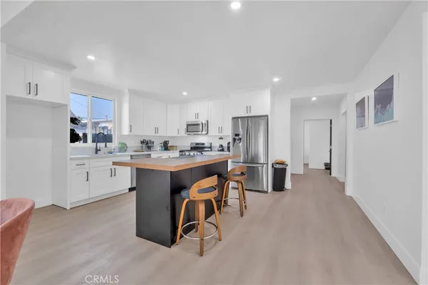 a kitchen with a sink cabinets and stainless steel appliances