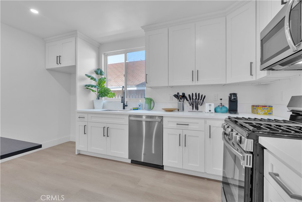 3115 Arvia Street, Unit 1A Los Angeles, CA 90065 - Photo 21 of 45 a kitchen with white cabinets and white appliances