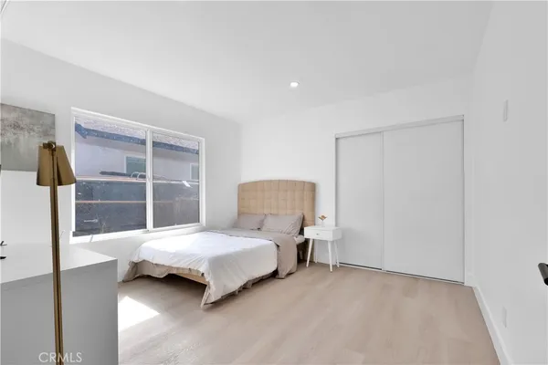 a bedroom with a bed and window