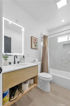 a bathroom with a sink a toilet and a bathtub