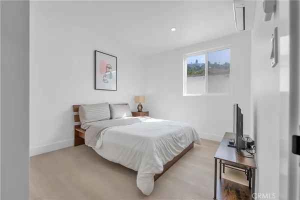 a bedroom with a bed and wall painting