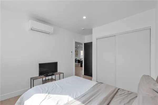 a bedroom with a bed and a flat screen tv