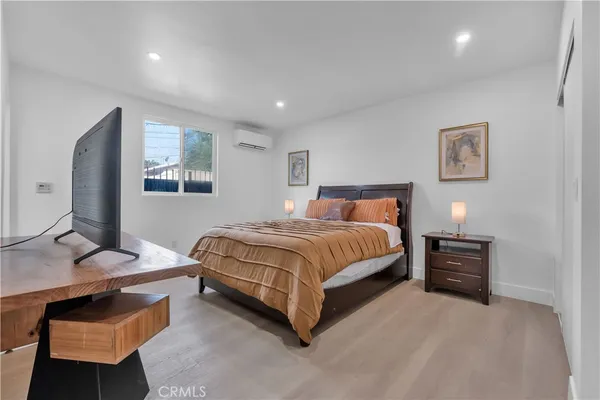 a bedroom with a bed and a flat screen tv
