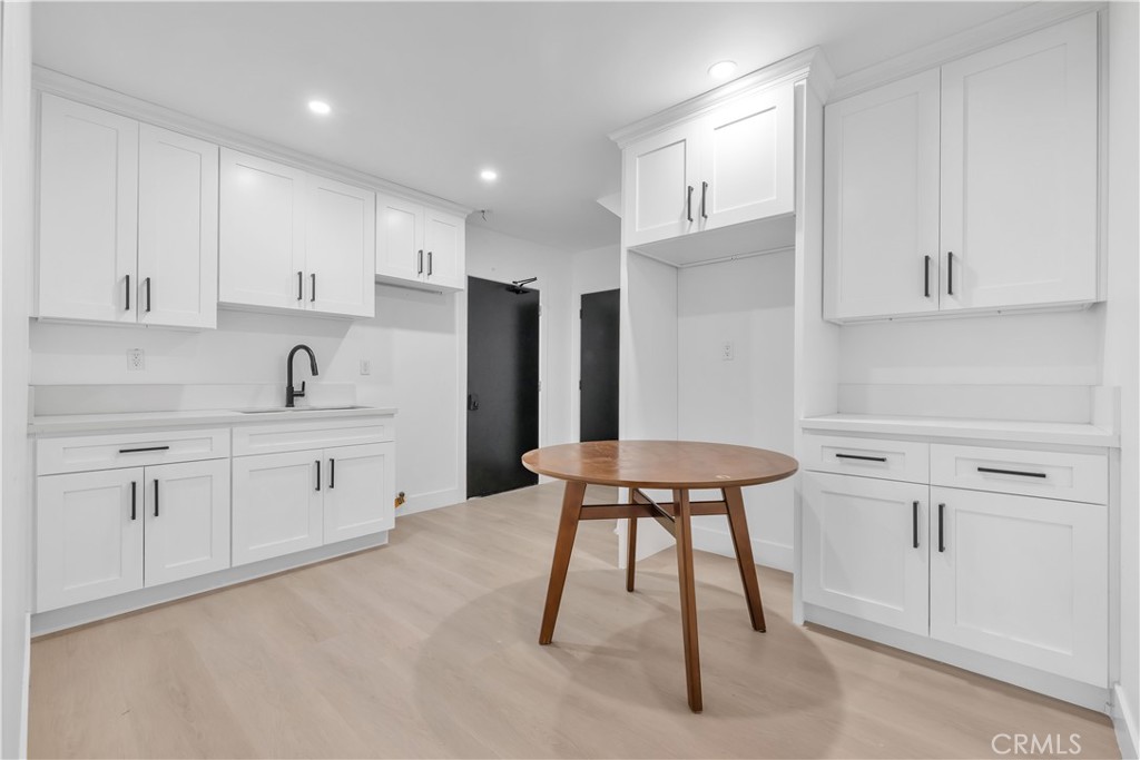3115 Arvia Street, Unit 1A Los Angeles, CA 90065 - Photo 38 of 45 a kitchen with a table chairs refrigerator and cabinets