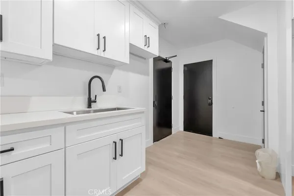 a kitchen with a sink and a refrigerator