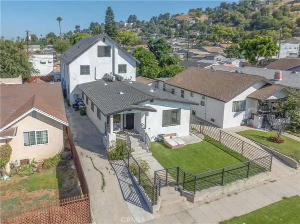 an aerial view of a house with a yard