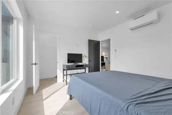 a bedroom with a bed and a television in it