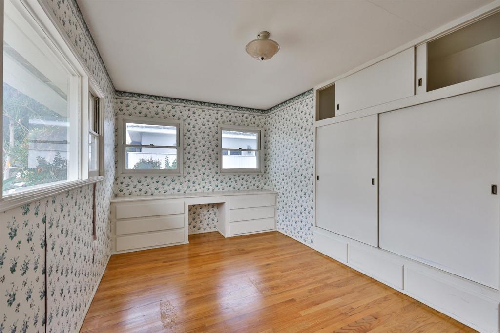 5930 Waverly Avenue La Jolla, CA 92037 - Photo 11 of 61 a view of an empty room with wooden floor and a window