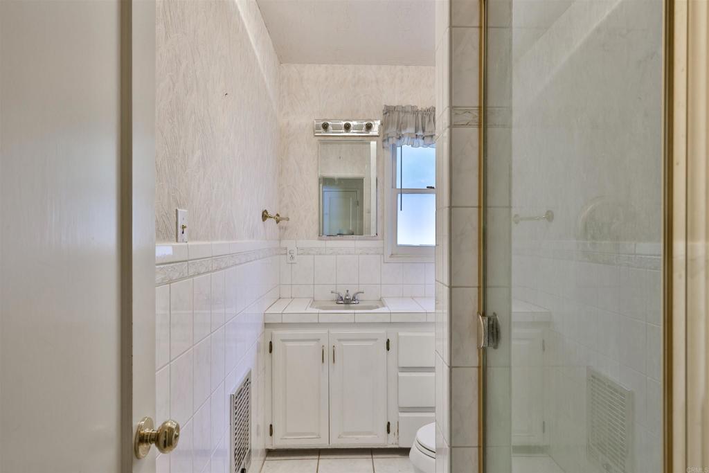 5930 Waverly Avenue La Jolla, CA 92037 - Photo 15 of 61 a bathroom with a sink and a mirror
