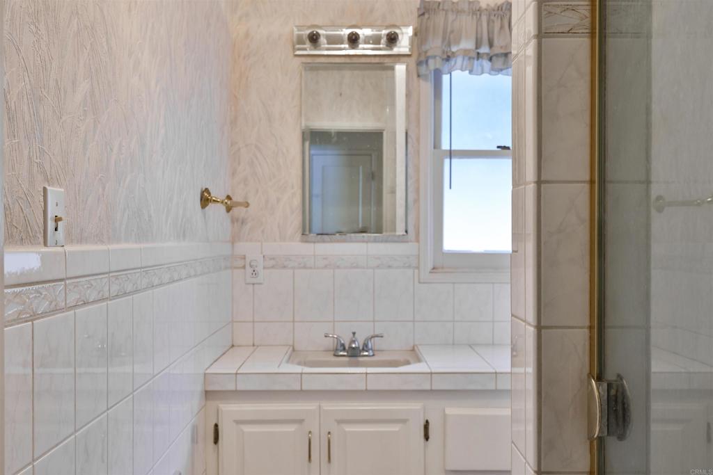 5930 Waverly Avenue La Jolla, CA 92037 - Photo 16 of 61 a bathroom with a sink and a mirror