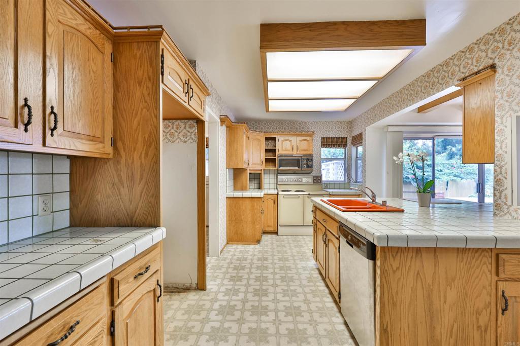 5930 Waverly Avenue La Jolla, CA 92037 - Photo 17 of 61 a kitchen with a stove and a refrigerator