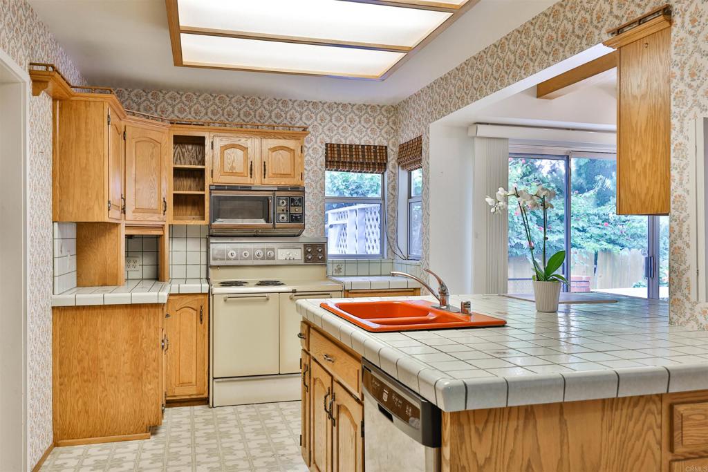 5930 Waverly Avenue La Jolla, CA 92037 - Photo 18 of 61 a kitchen with stainless steel appliances granite countertop a sink and a stove