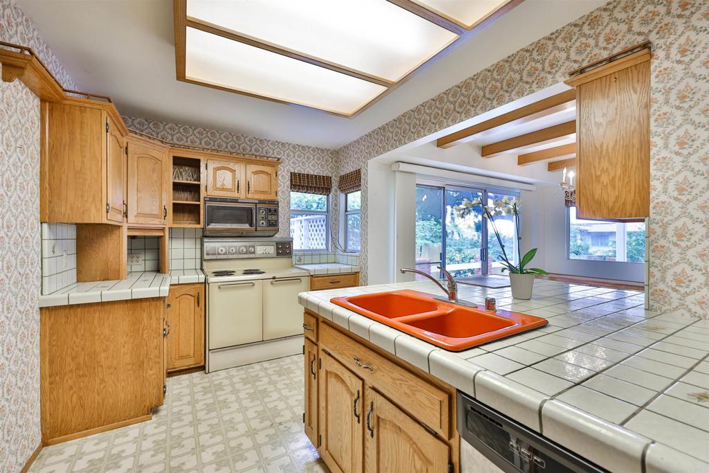 5930 Waverly Avenue La Jolla, CA 92037 - Photo 20 of 61 a kitchen that has a sink and a stove