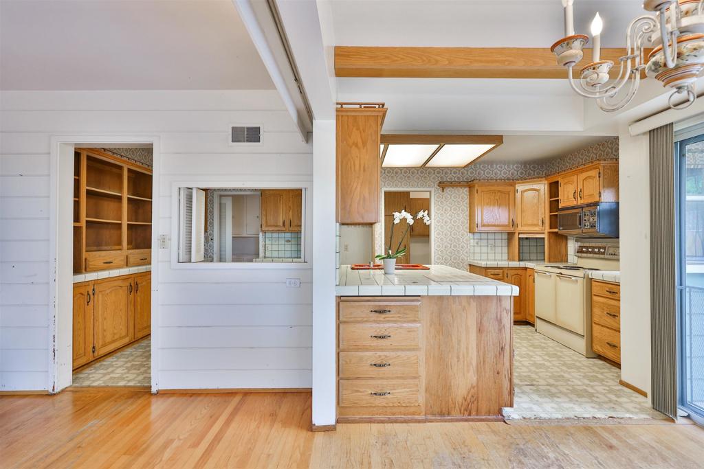 5930 Waverly Avenue La Jolla, CA 92037 - Photo 22 of 61 a kitchen with a wooden floor and cabinets