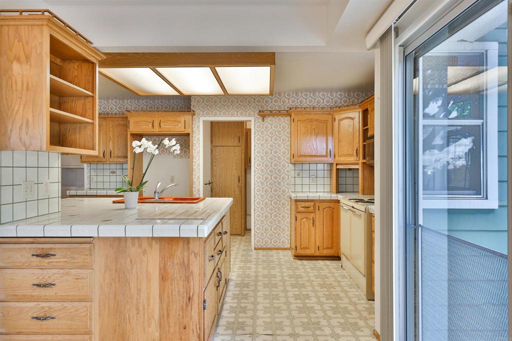 5930 Waverly Avenue La Jolla, CA 92037 - Photo 23 of 61 a kitchen with kitchen island granite countertop a sink and a refrigerator