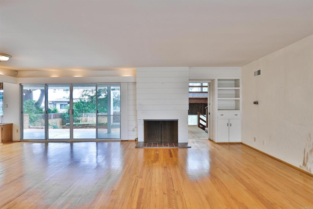 5930 Waverly Avenue La Jolla, CA 92037 - Photo 31 of 61 wooden floor fireplace and natural light in room