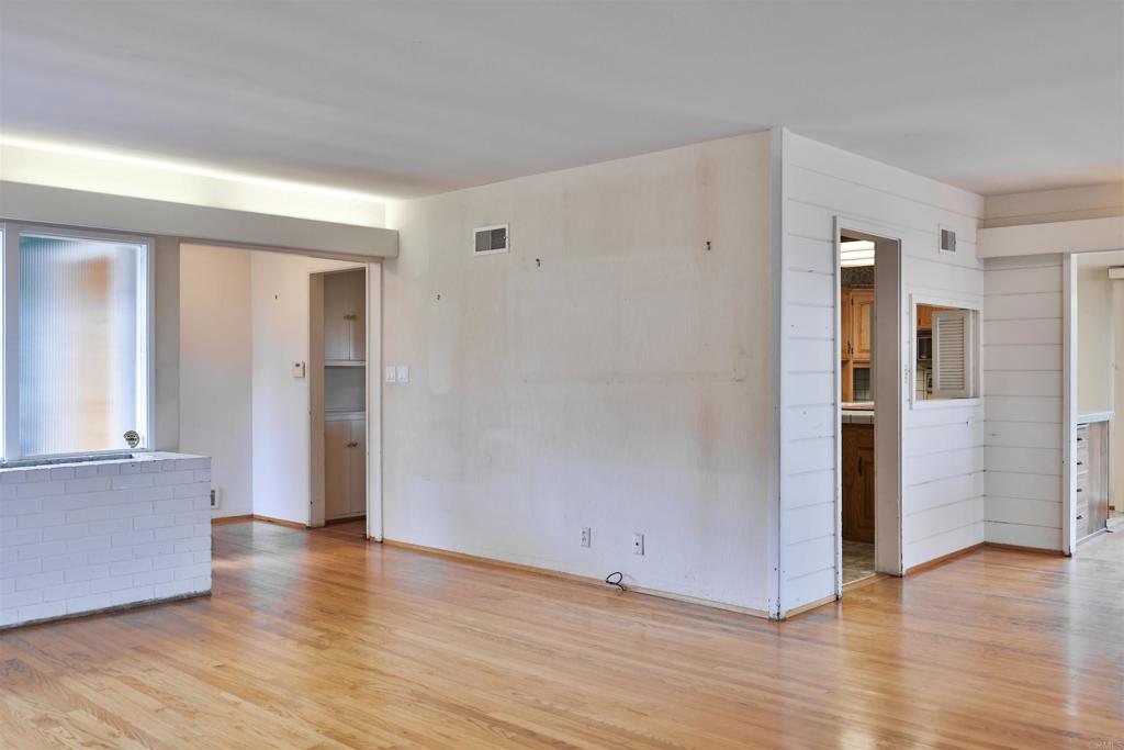 5930 Waverly Avenue La Jolla, CA 92037 - Photo 34 of 61 an empty room with wooden floor and windows