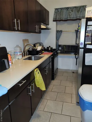 a kitchen with a sink a stove and cabinets