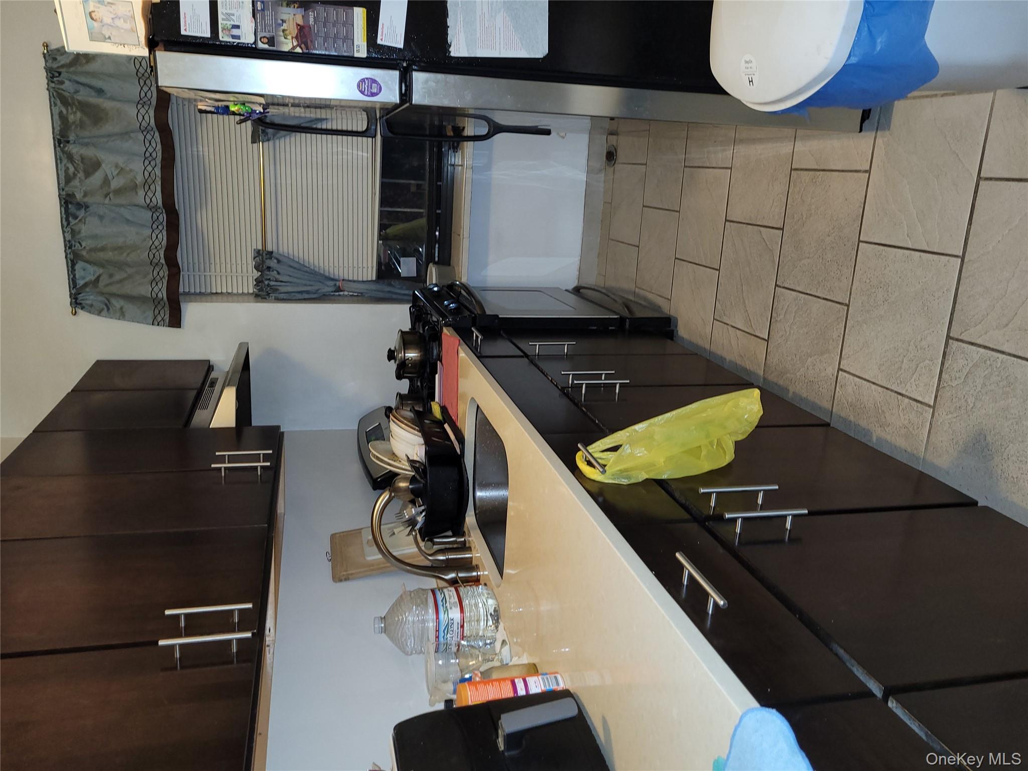 a kitchen with a sink a stove and cabinets