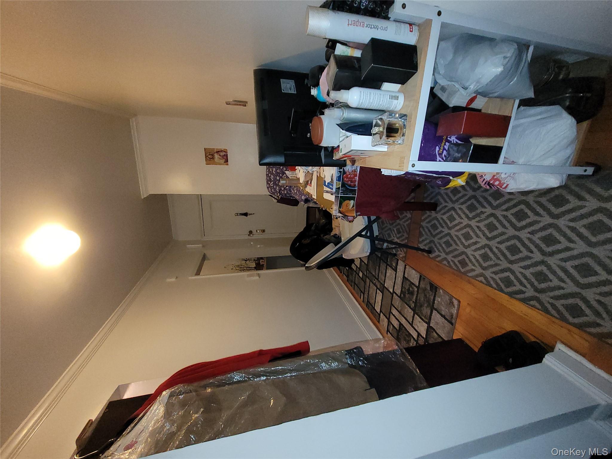 2209 76th Street, Unit C2 Queens, NY 11370 - Photo 5 of 5 a living room with furniture and a rug