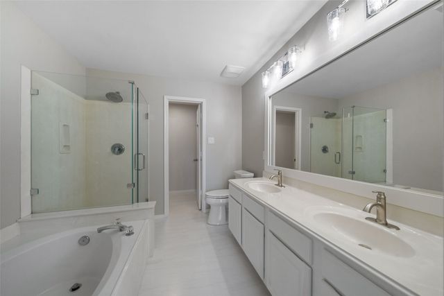 a bathroom with a double vanity sink and mirror with shower