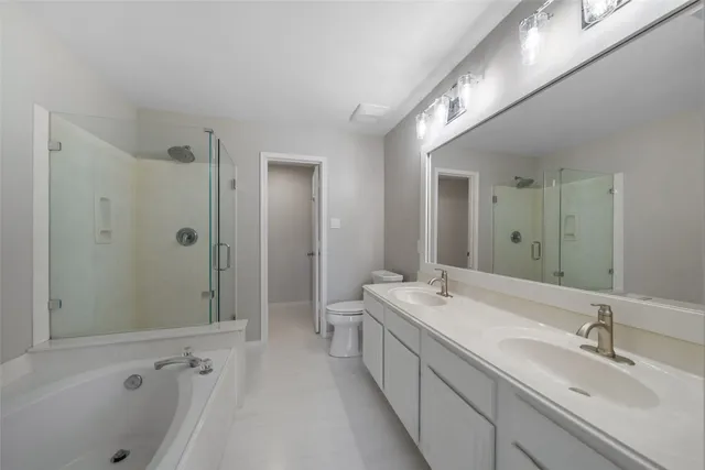 a bathroom with a double vanity sink and mirror with shower