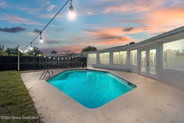 a view of a backyard with swimming pool