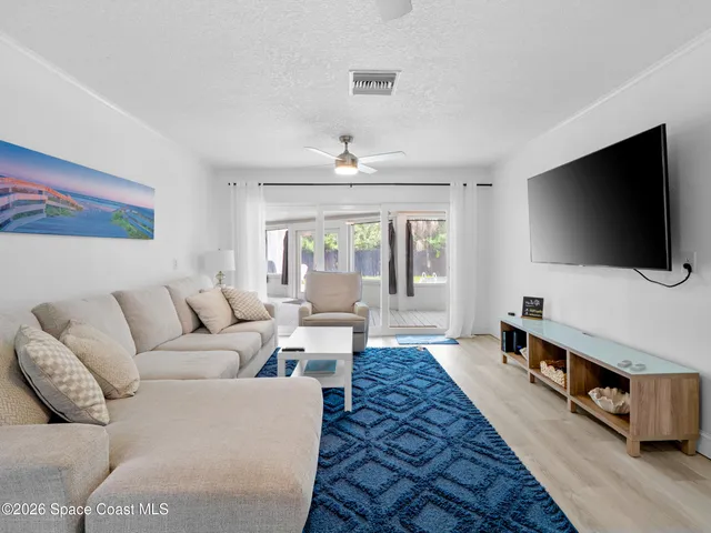 a bedroom with two beds and a chandelier