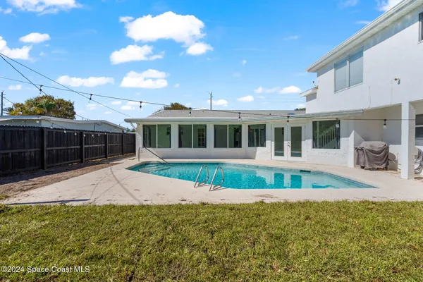 an aerial view of a house with a swimming pool yard and outdoor seating