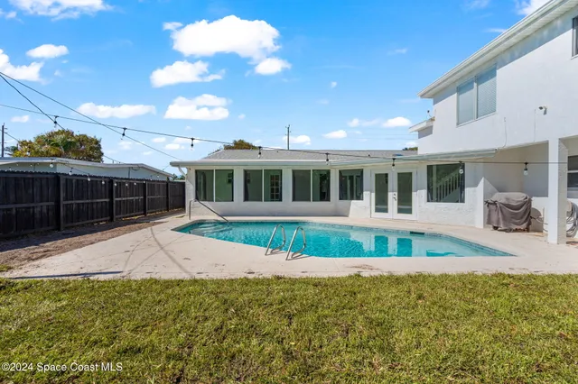 an aerial view of a house with a swimming pool yard and outdoor seating