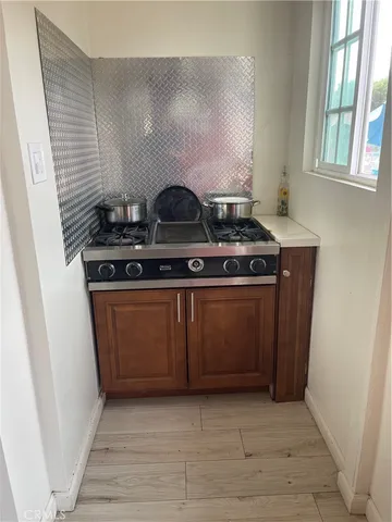 a stove top oven sitting inside of a kitchen
