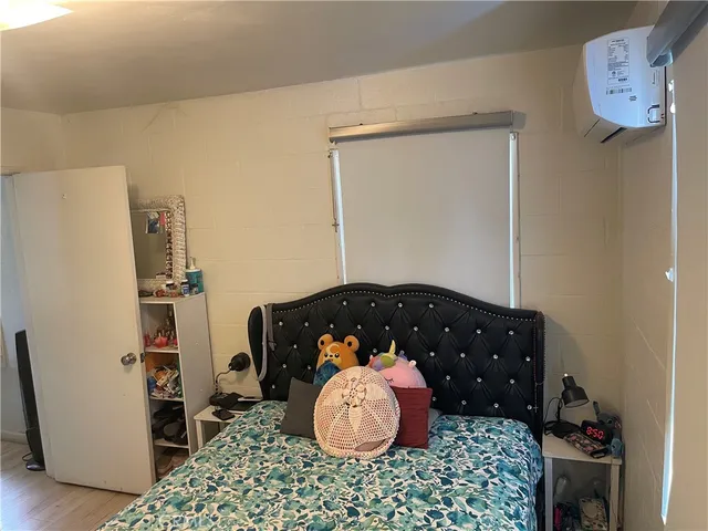 a bedroom with a bed and a table in it