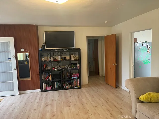 a view of a livingroom with furniture and an empty room