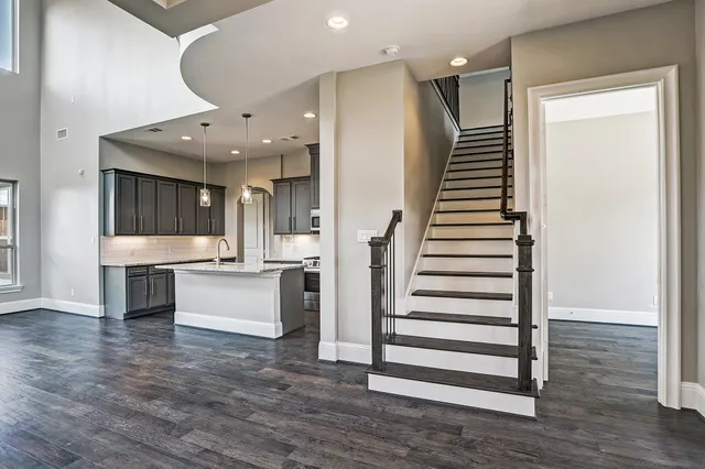 an entryway with wooden floor and windows