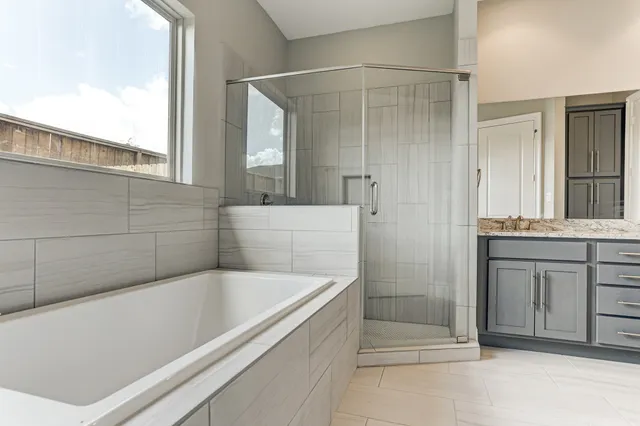 a bathroom with a bathtub and a sink