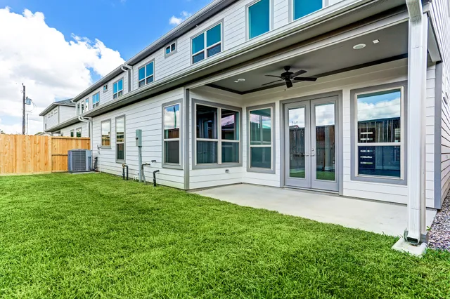 a view of a backyard with potted plants and wooden fence