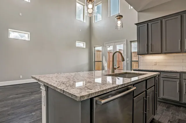 a kitchen with a sink cabinets and wooden floor