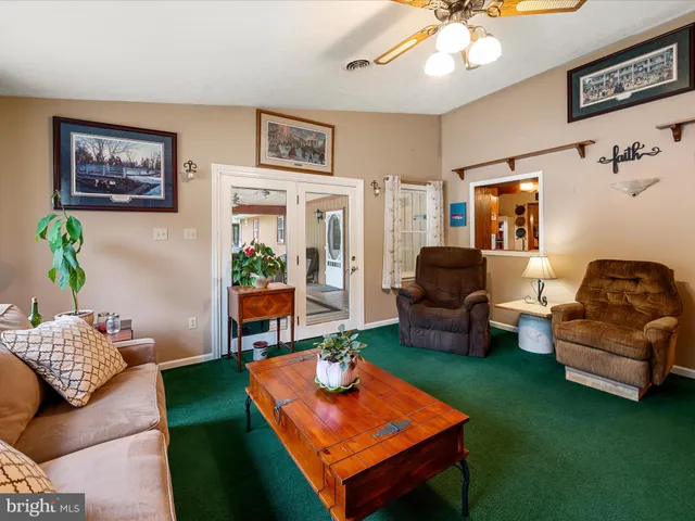 a bed sitting in a spacious bedroom next to a window