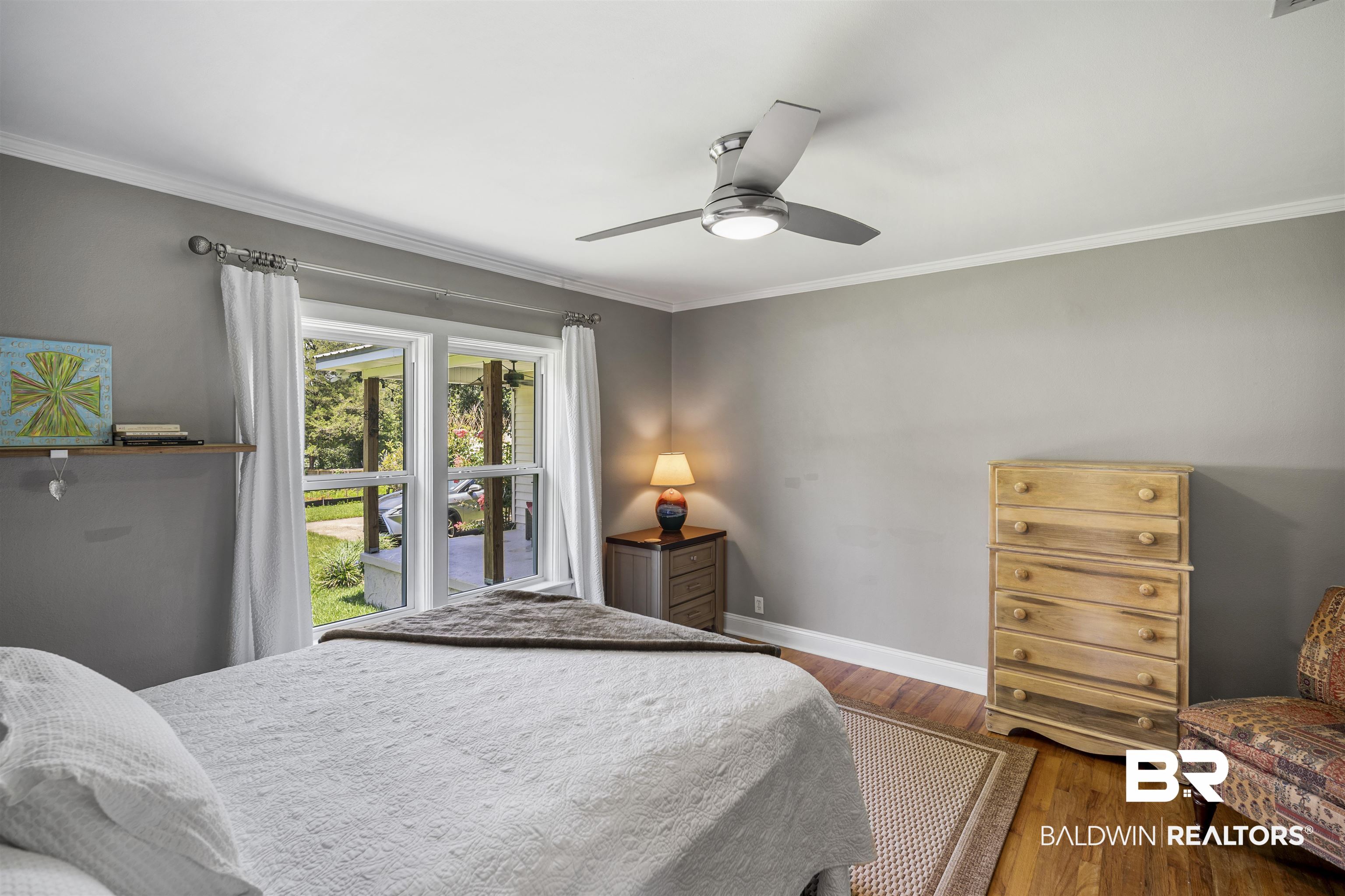 1615 5th Street Daphne, AL 36526 - Photo 19 of 28 Interior room featuring wood-finish flooring, a contemporary ceiling fan with integrated lighting, and a window with white trim