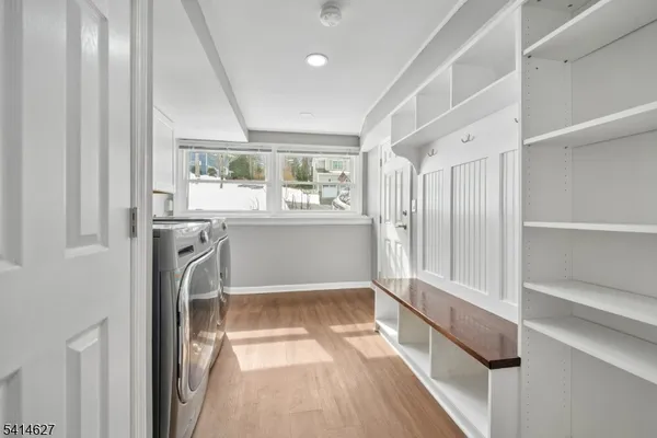 a view of a kitchen with wooden floor and a window