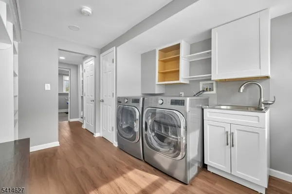 a utility room with sink dryer and washer
