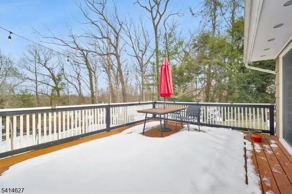 a view of balcony with wooden floor and fence