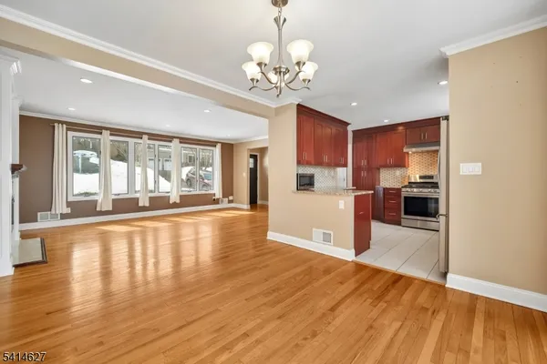 a view of a kitchen with wooden floor and a kitchen