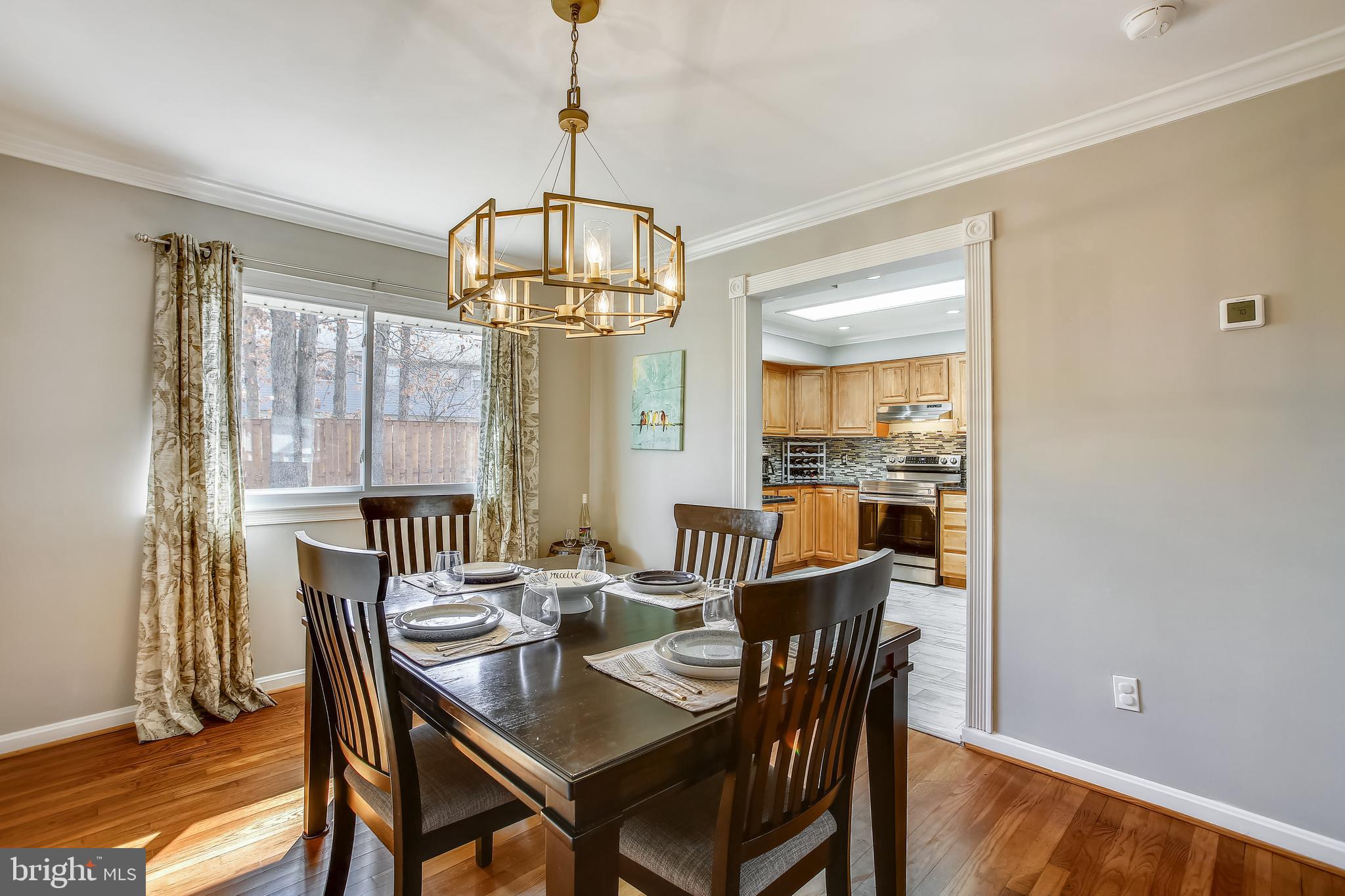 6005 Filbert Court Springfield, VA 22152 - Photo 17 of 55 a dining room with furniture a chandelier and wooden floor